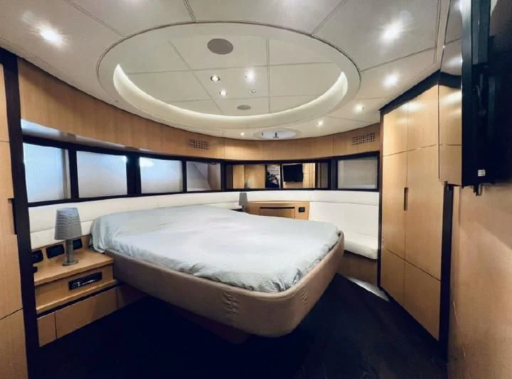 a room with a bed and a desk aboard GIGAONE Yacht for Sale