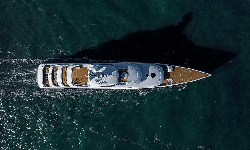 a bottle of beer on a beach aboard ZEN Yacht for Charter