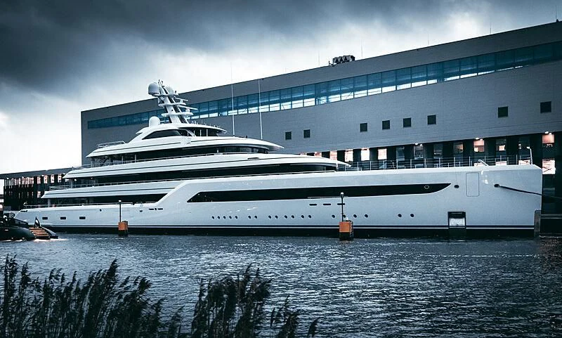 a large white yacht in front of a building aboard ZEN Yacht for Charter