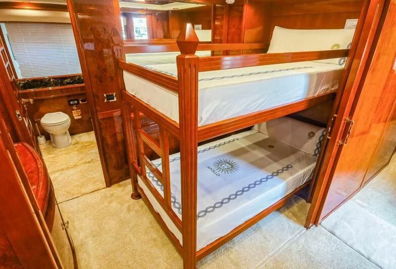 a bed with a wooden frame aboard APOLLO I Yacht for Sale