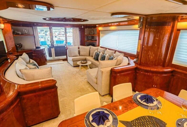 a living room with a wood wall aboard APOLLO I Yacht for Sale