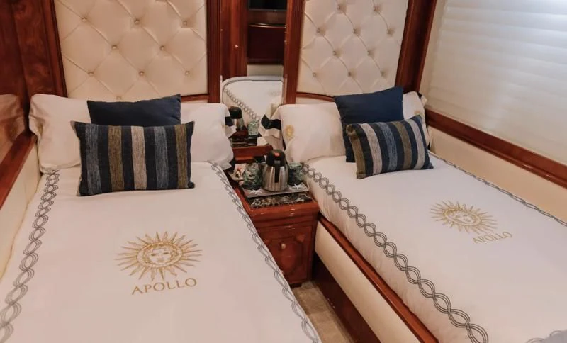 a room with a bed and a dresser aboard APOLLO I Yacht for Sale
