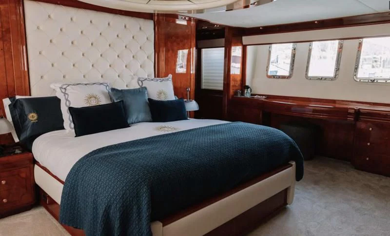 a bed with blue sheets aboard APOLLO I Yacht for Sale