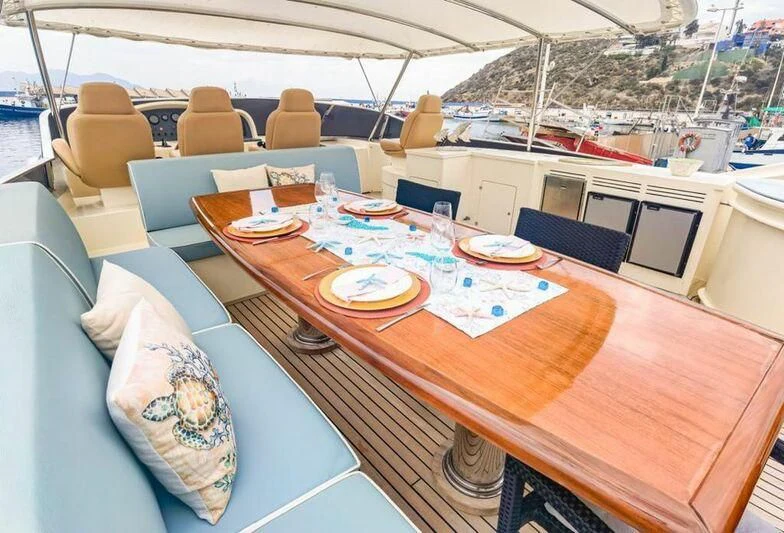 a table with plates and chairs on it aboard APOLLO I Yacht for Sale