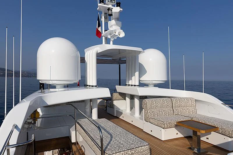 a boat with a white bed and a white chair on the deck aboard A2 Yacht for Sale