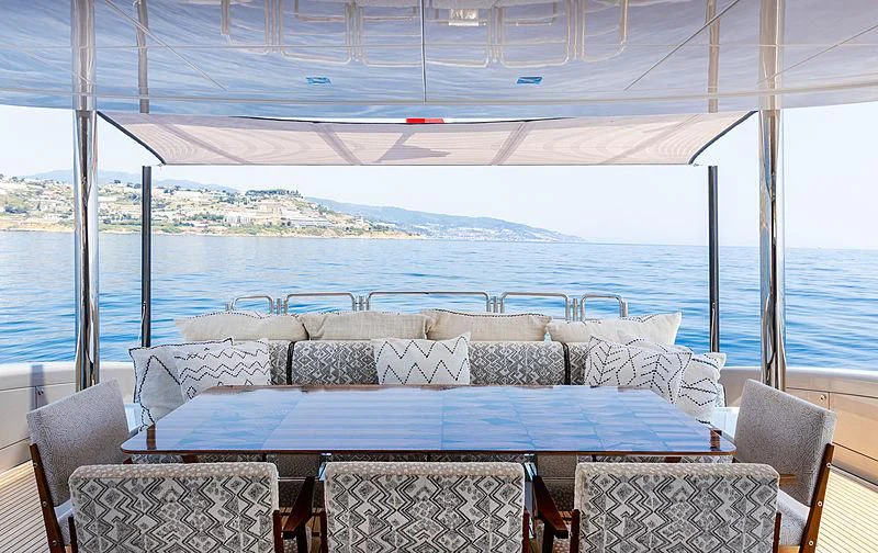 a table with chairs around it aboard A2 Yacht for Sale