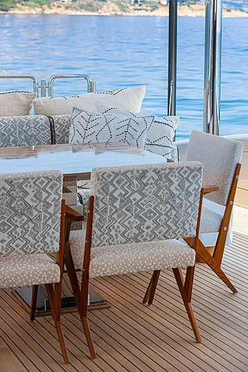 a table and chairs on a deck aboard A2 Yacht for Sale