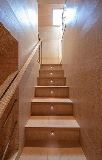 a wooden staircase with a white tile floor aboard A2 Yacht for Sale