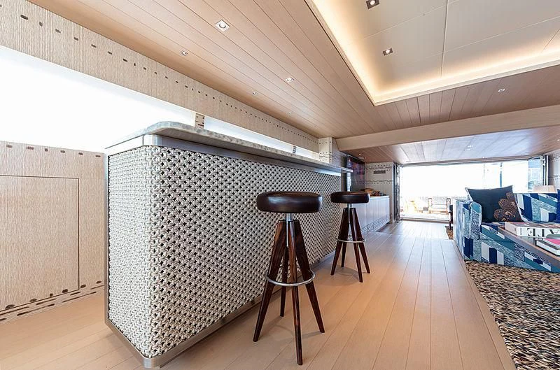 a room with a bed and stools aboard A2 Yacht for Sale