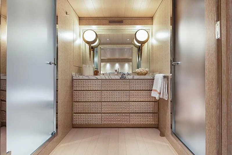 a bathroom with wooden cabinets aboard A2 Yacht for Sale
