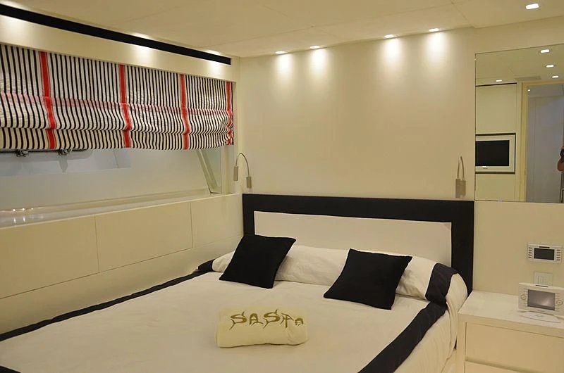 a room with a bed and a red and white striped bed aboard MAI Yacht for Sale