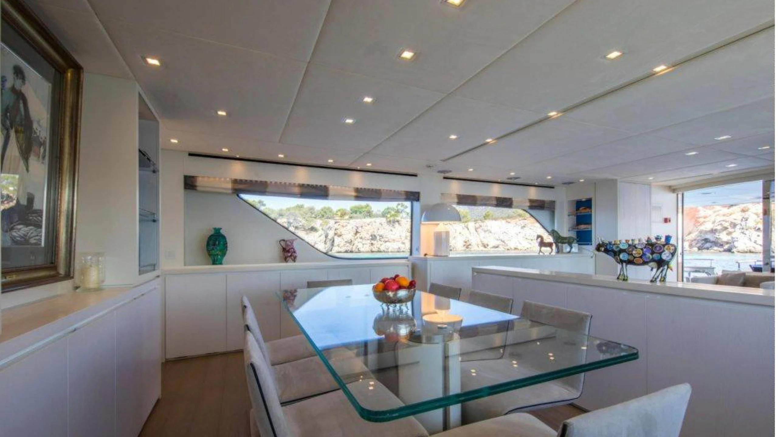 a large kitchen with a large table aboard MAI Yacht for Sale