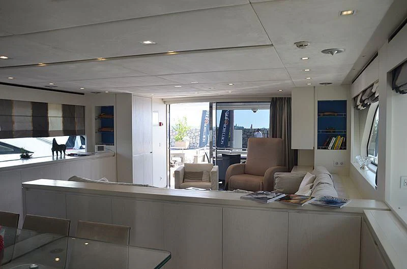 a room with a couch and a television on the wall aboard MAI Yacht for Sale