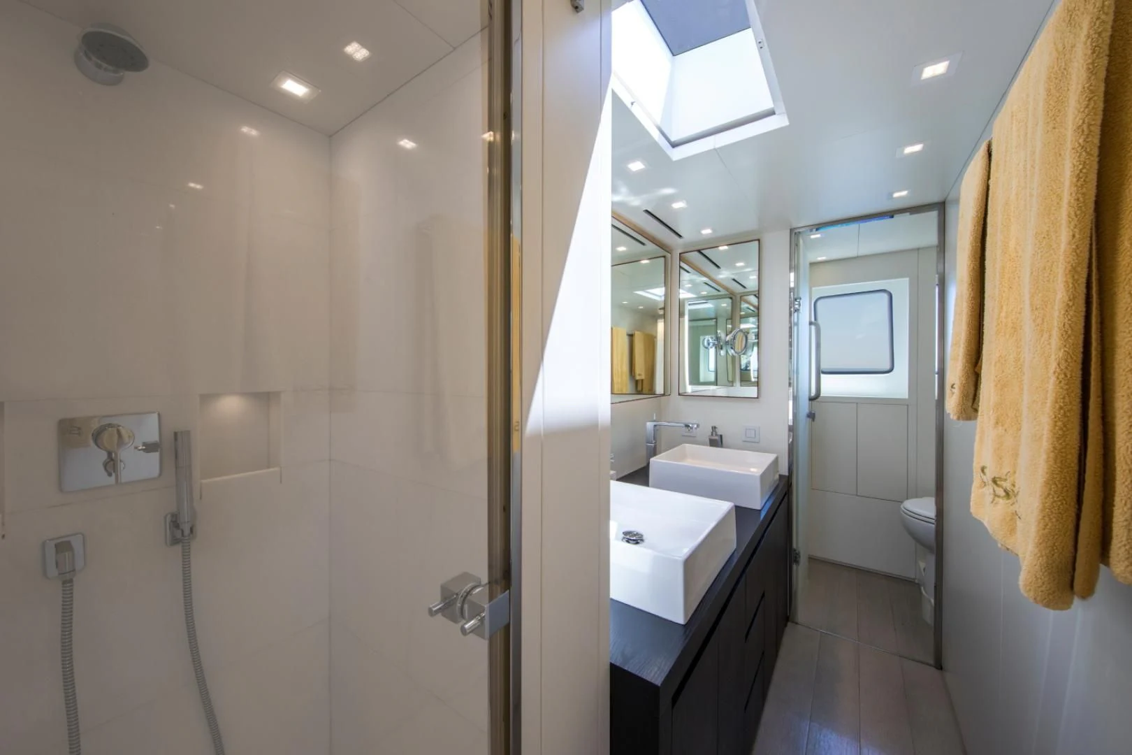 a bathroom with a shower and sinks aboard MAI Yacht for Sale