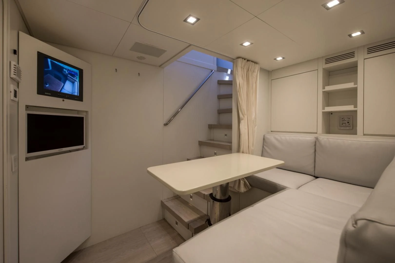 a room with a couch and a television aboard MAI Yacht for Sale
