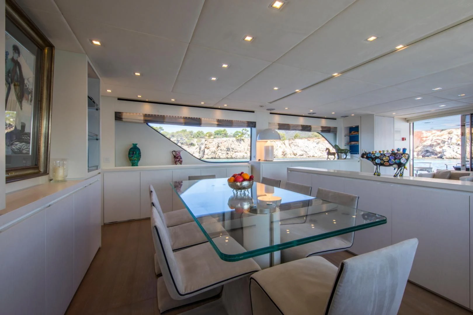 a modern looking kitchen with a large table and chairs aboard MAI Yacht for Sale