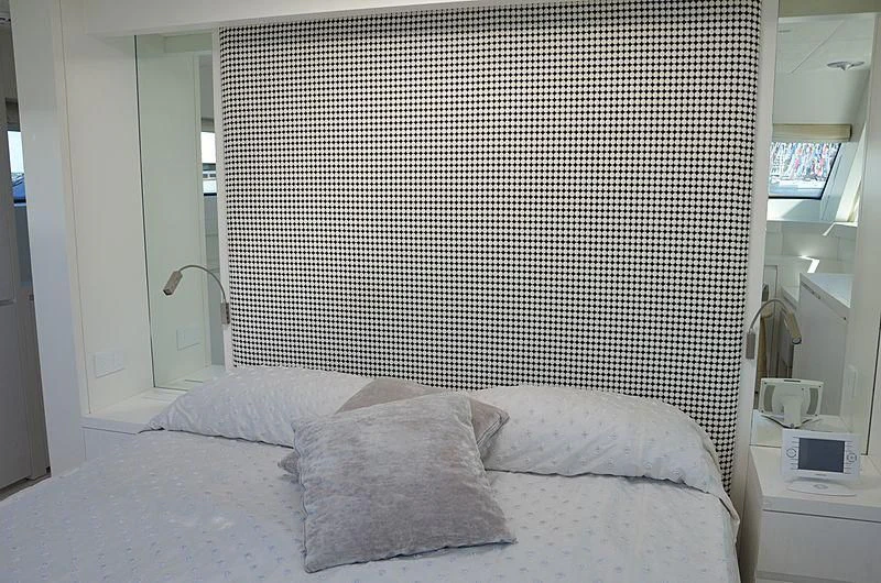 a bed with a white pillow aboard MAI Yacht for Sale