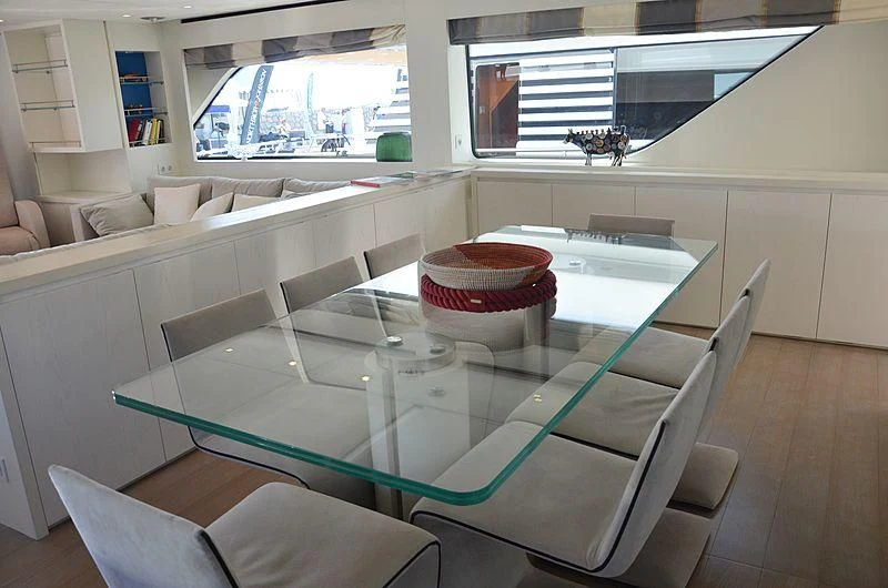 a table with chairs and a couch aboard MAI Yacht for Sale