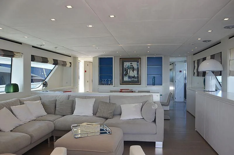 a living room with a couch and a table aboard MAI Yacht for Sale