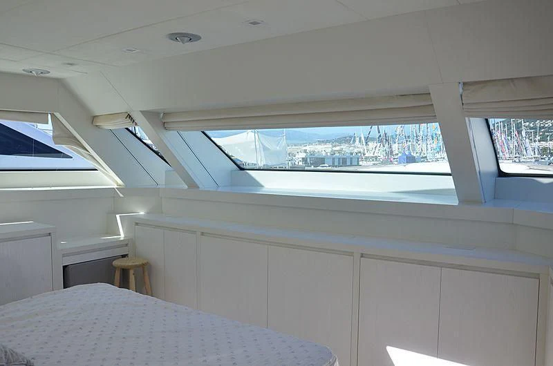 a room with a table and a bed aboard MAI Yacht for Sale
