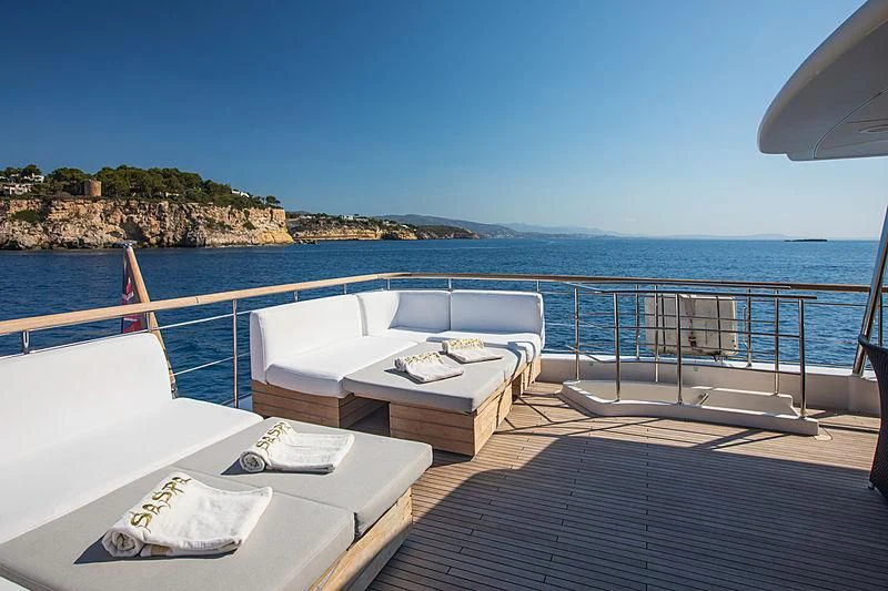 a large pool with a bed and a table on it aboard MAI Yacht for Sale