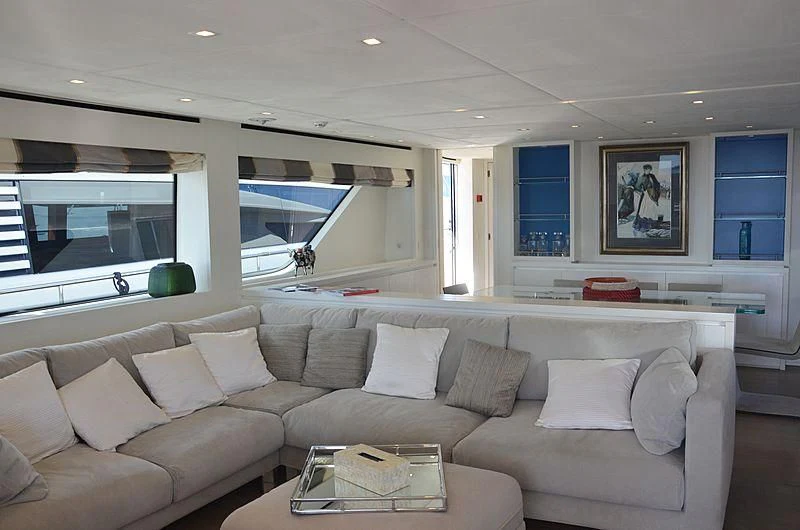 a living room with a couch and a table aboard MAI Yacht for Sale