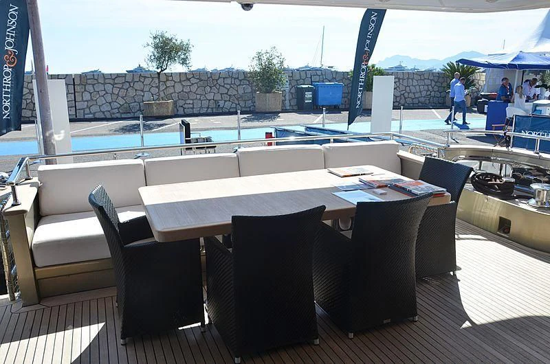 a large conference room with tables and chairs aboard MAI Yacht for Sale