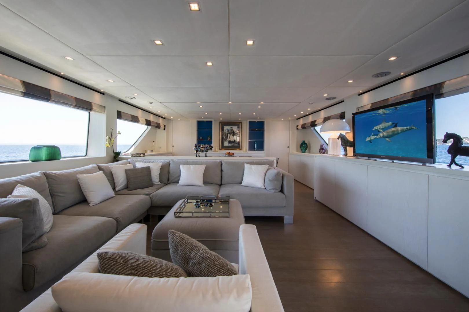 a living room with a large sofa and a tv aboard MAI Yacht for Sale