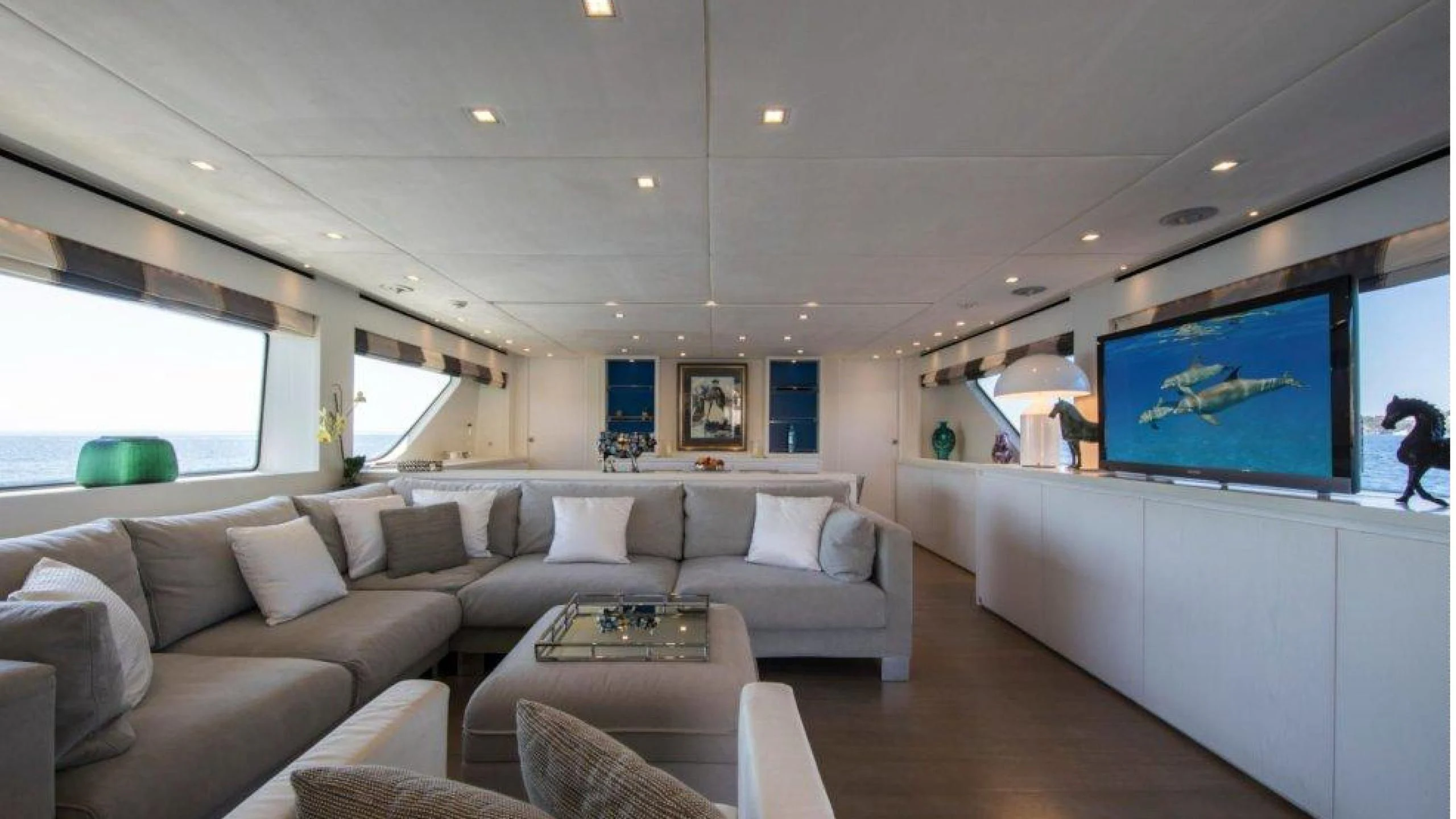 a living room with a large screen aboard MAI Yacht for Sale