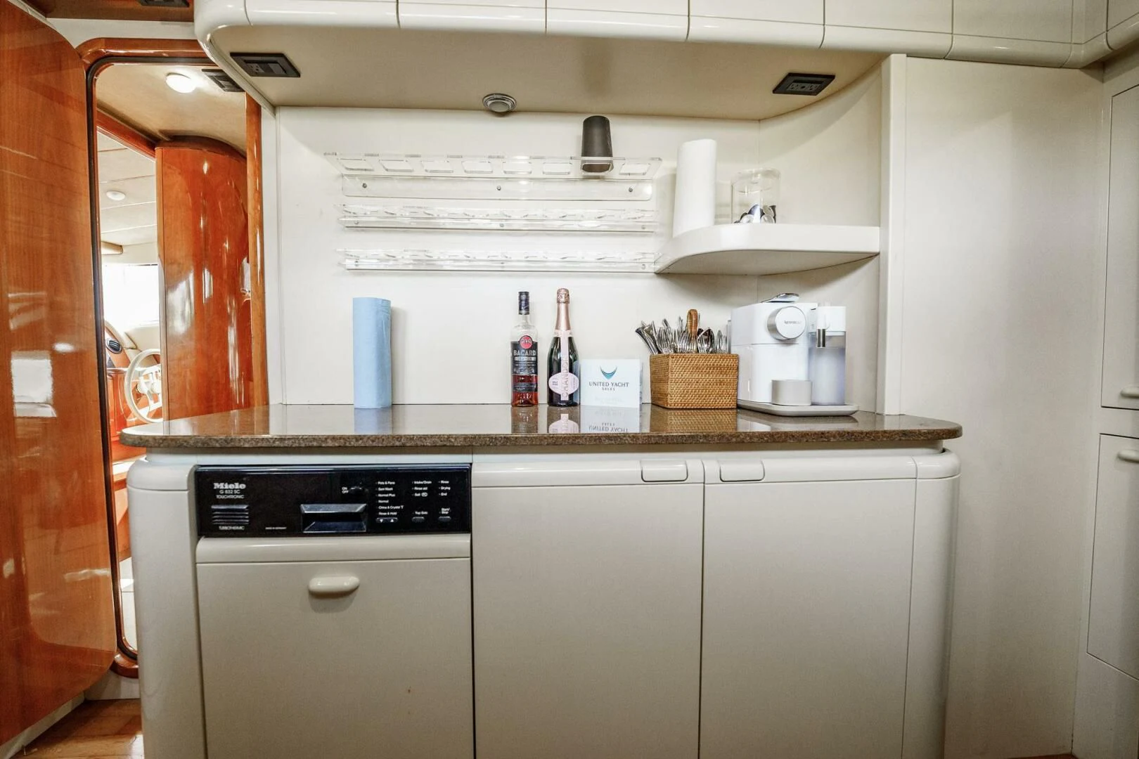 a kitchen with a white refrigerator aboard RABBIT Yacht for Sale