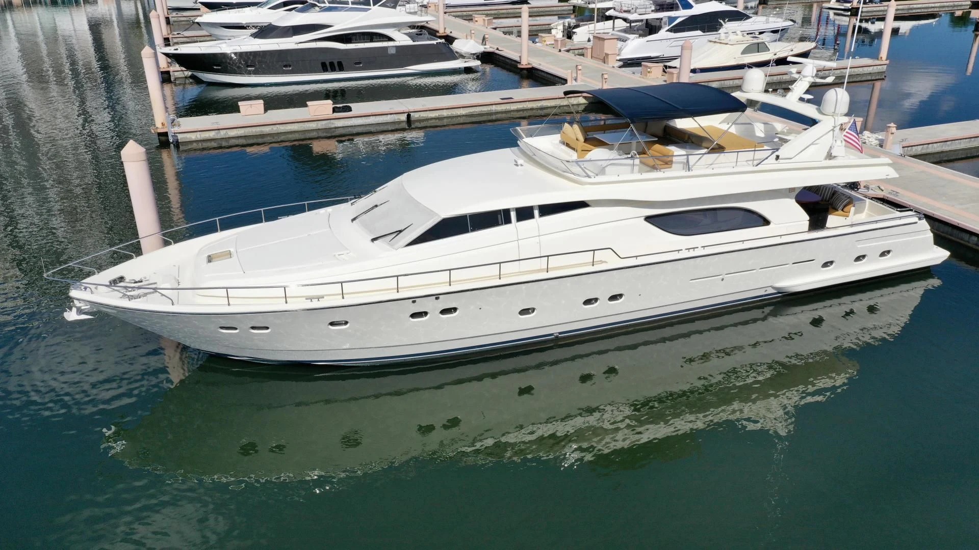a white yacht docked at a pier aboard RABBIT Yacht for Sale