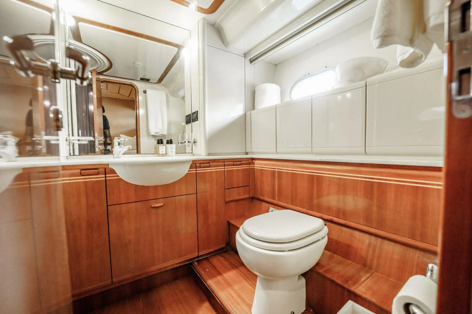 a bathroom with a toilet and a mirror aboard RABBIT Yacht for Sale