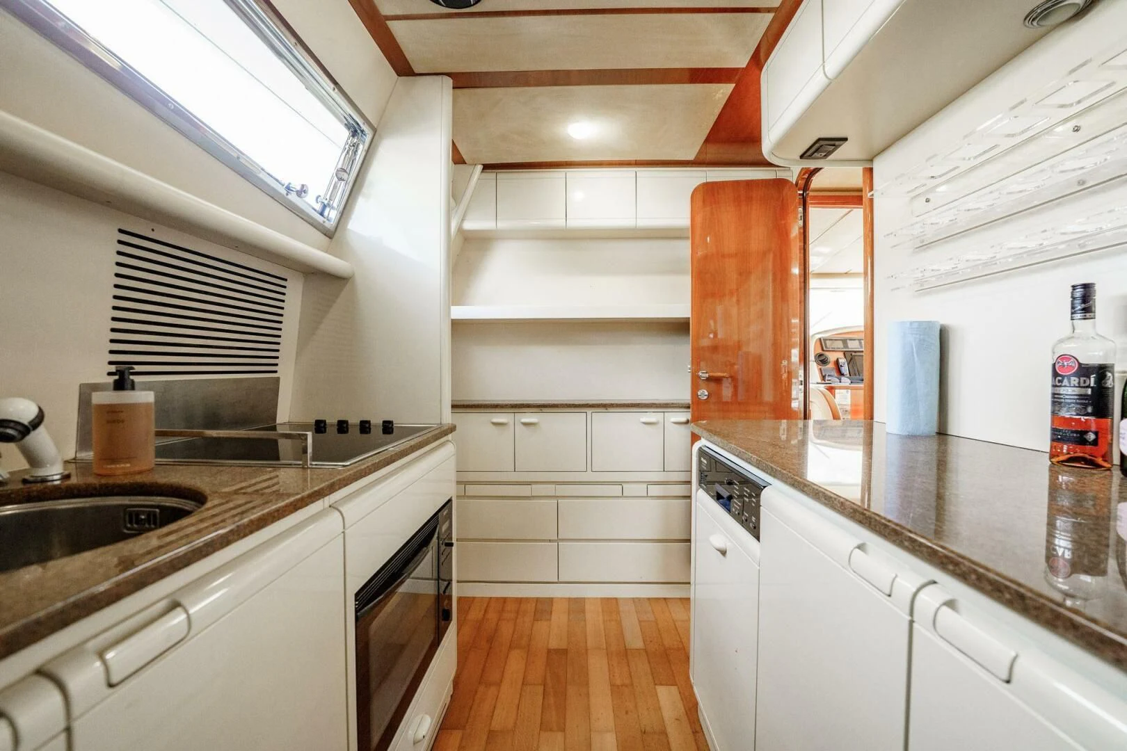 a kitchen with white cabinets aboard RABBIT Yacht for Sale