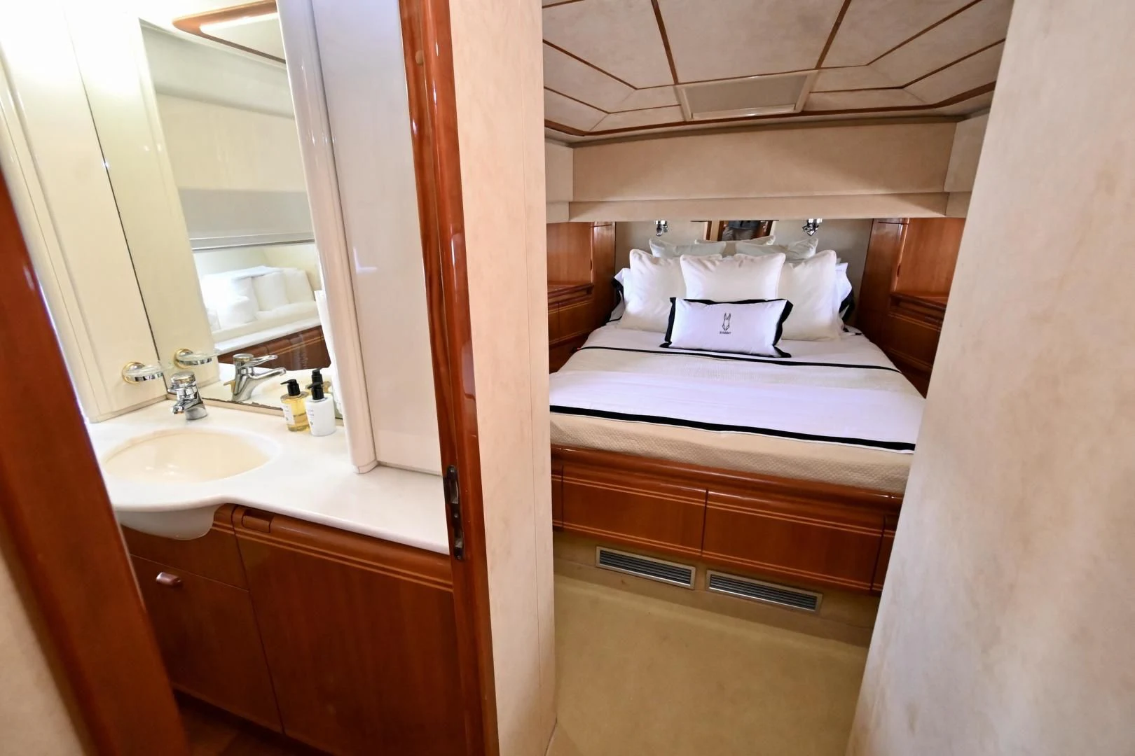 a bathroom with a sink and a bed aboard RABBIT Yacht for Sale