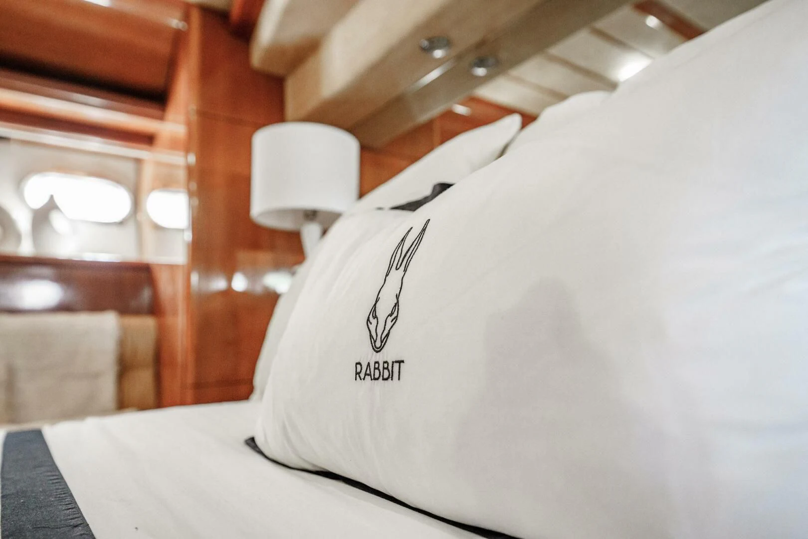 a white pillow on a bed aboard RABBIT Yacht for Sale