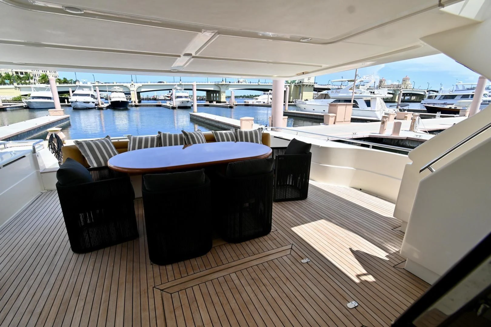 a room with a table chairs and a pool aboard RABBIT Yacht for Sale
