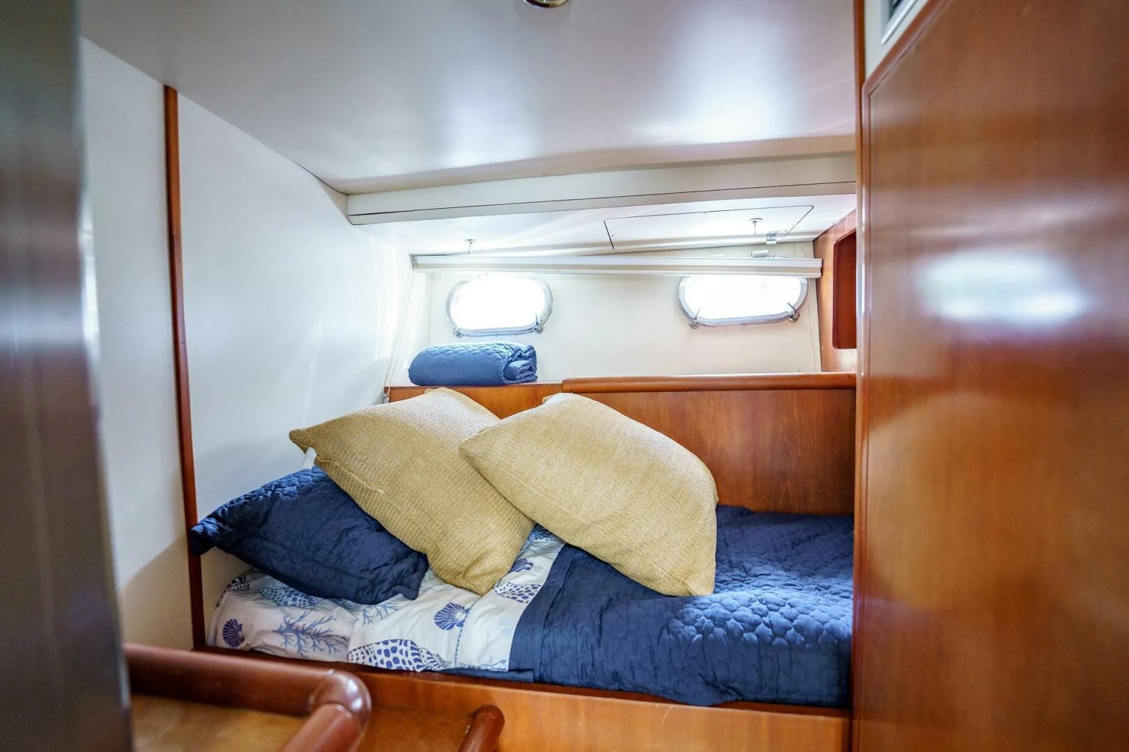 a bed with a blue blanket aboard RABBIT Yacht for Sale