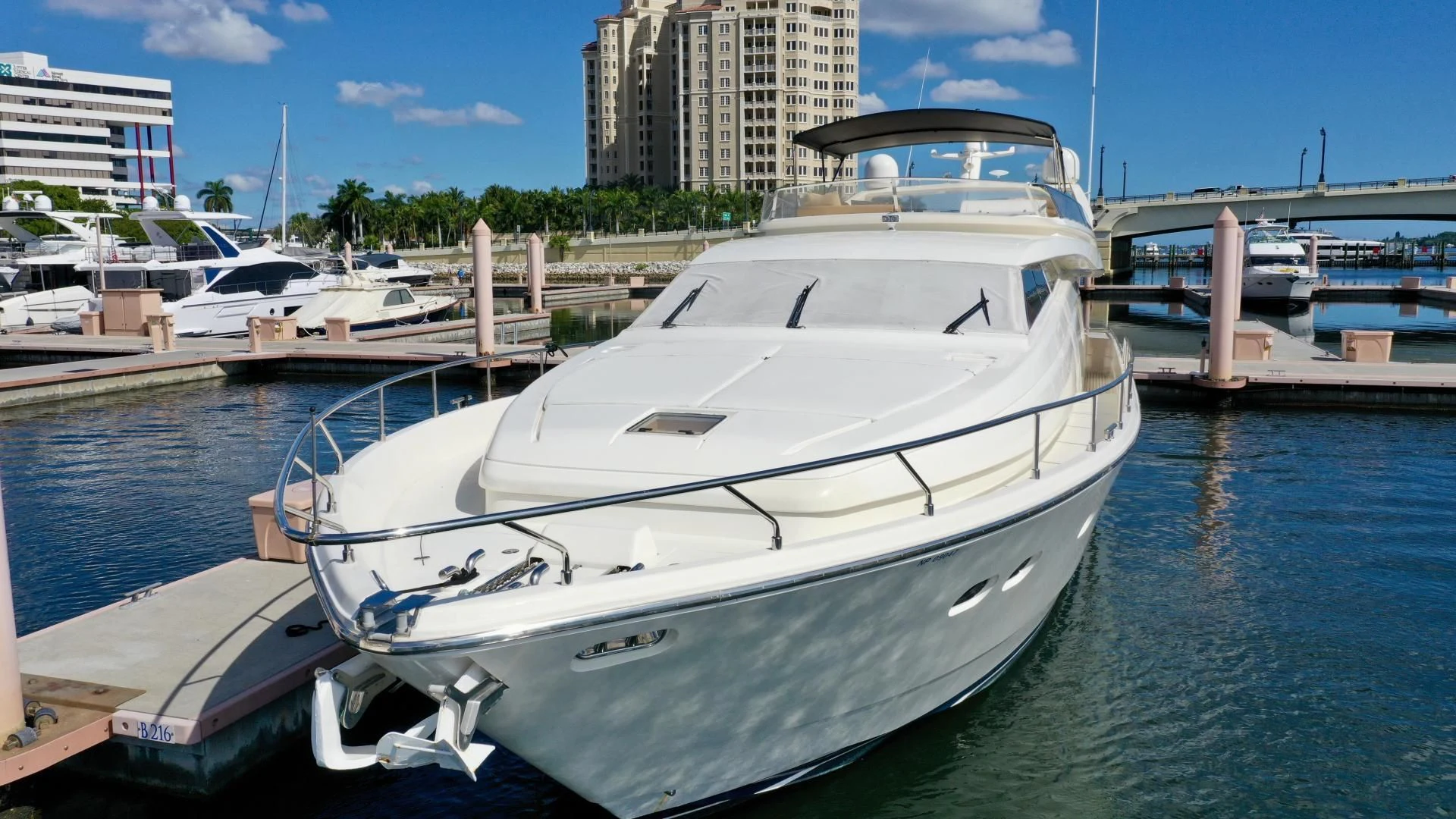 a white yacht docked at a pier aboard RABBIT Yacht for Sale