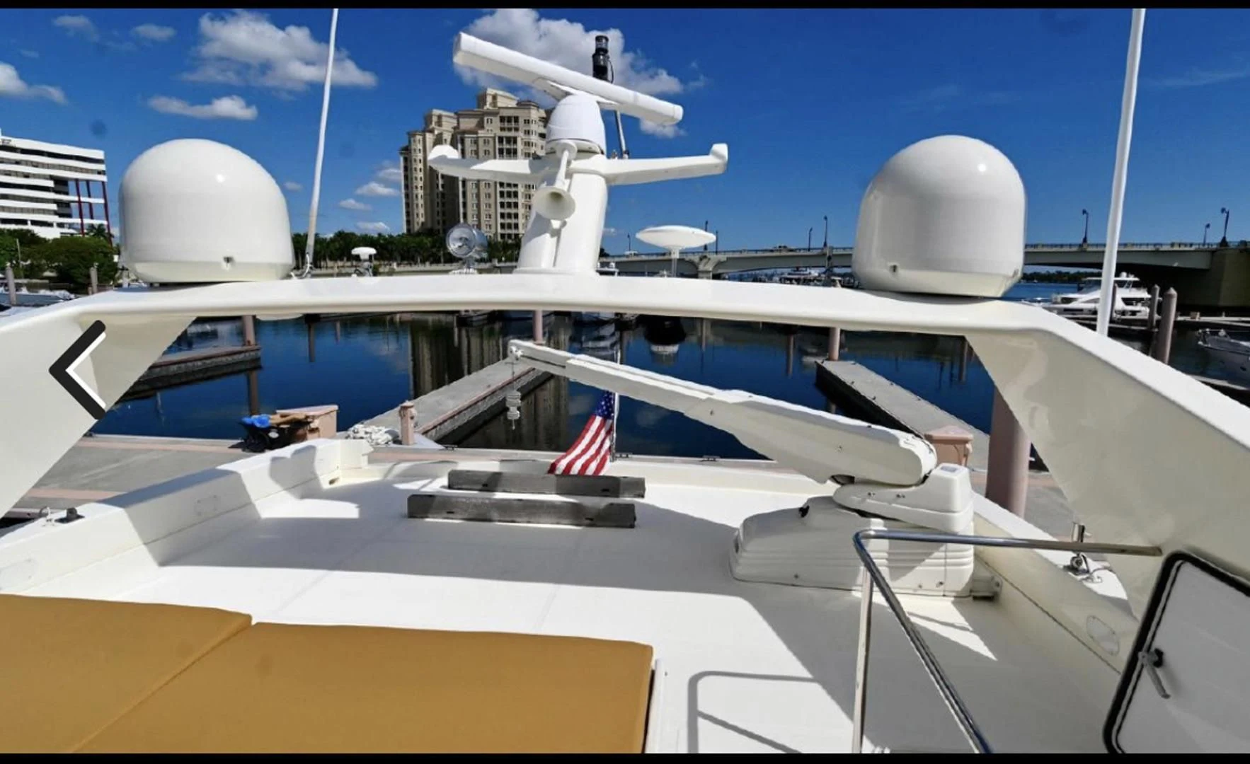 a view of a plane wing and a building with a flag on the roof aboard RABBIT Yacht for Sale