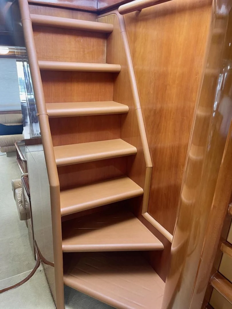 a wooden staircase with a glass door aboard RABBIT Yacht for Sale