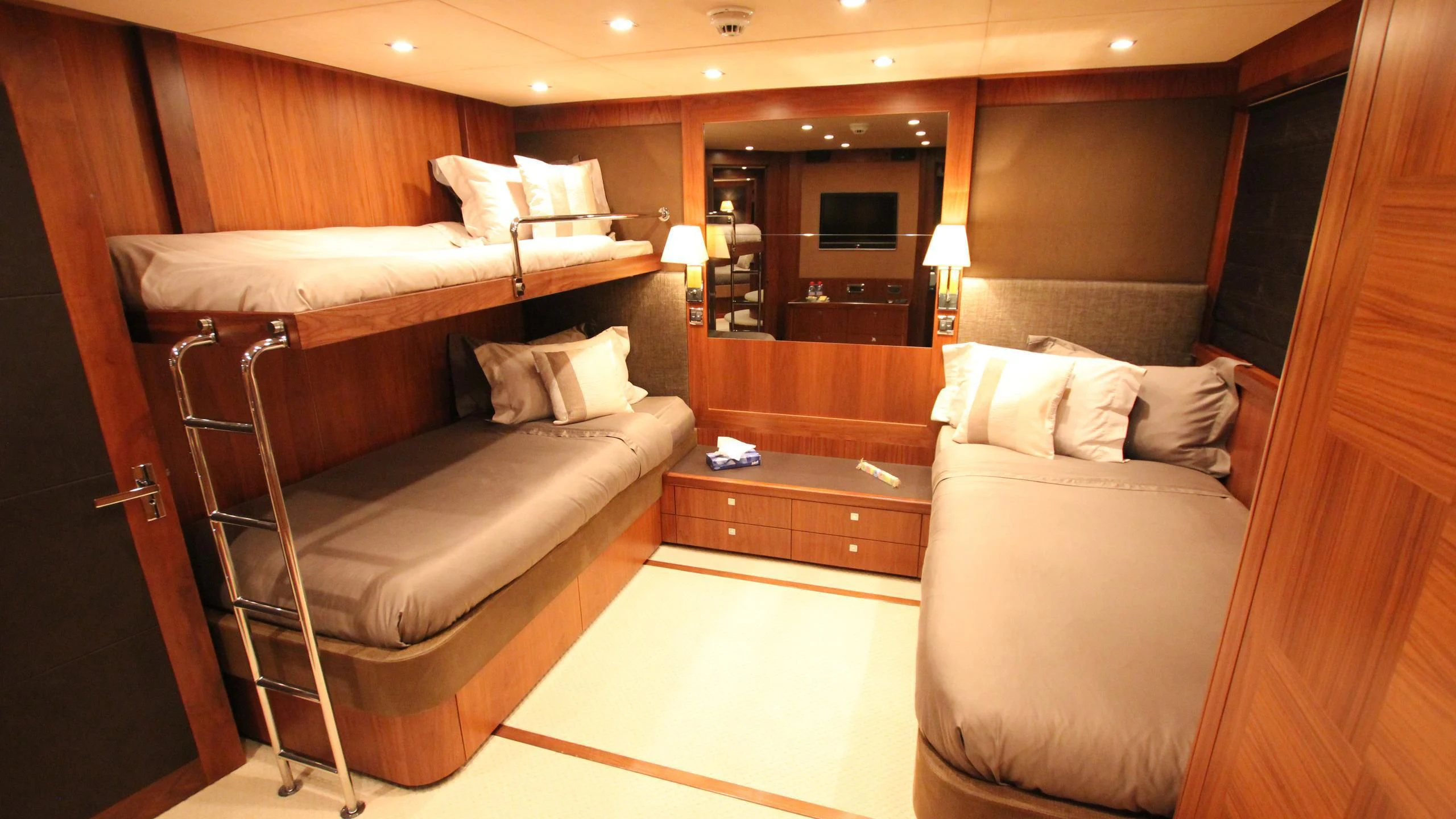 a room with a bed and a television aboard THE DEVOCEAN Yacht for Sale