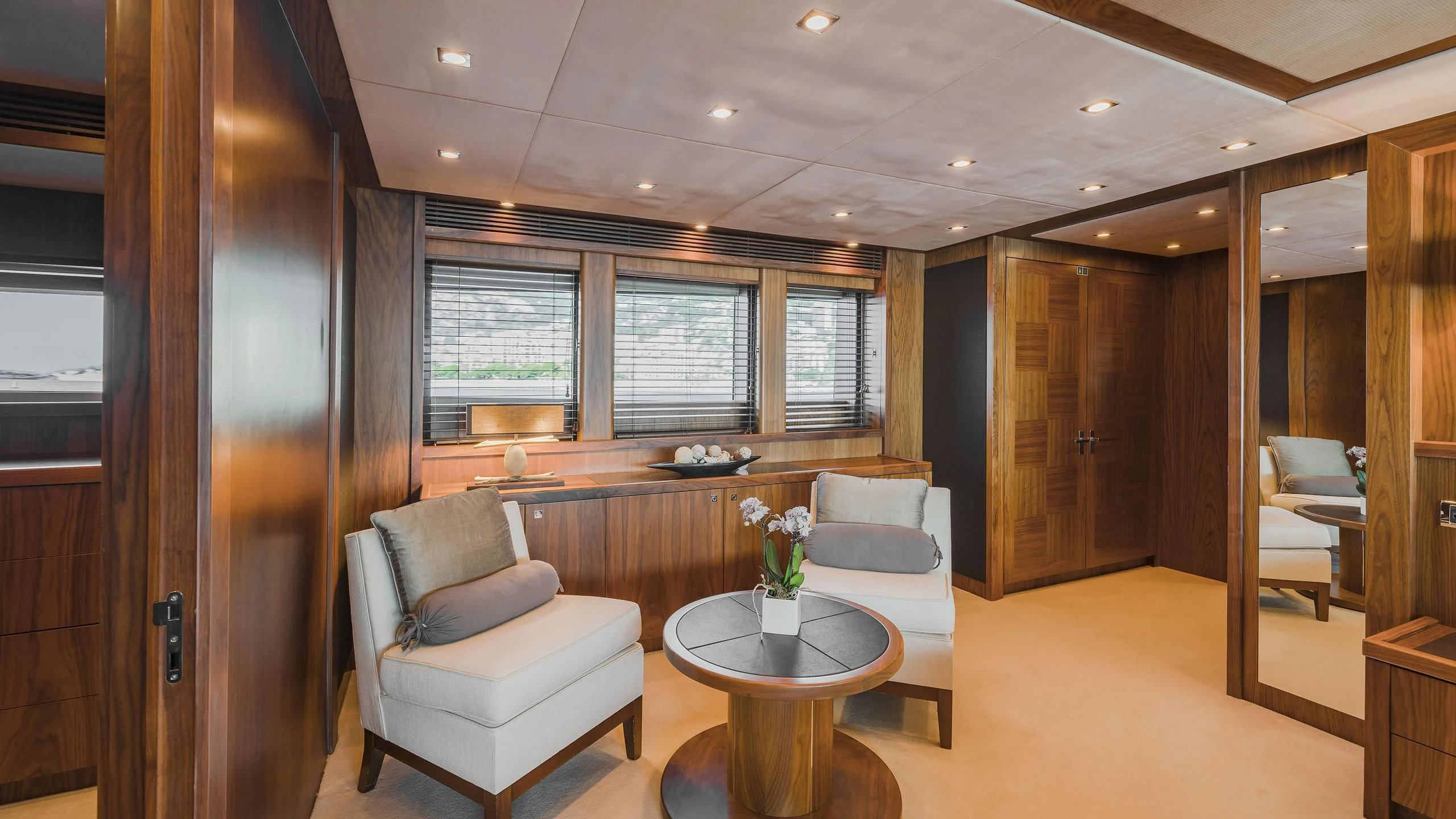 a living room with a table and chairs aboard THE DEVOCEAN Yacht for Sale