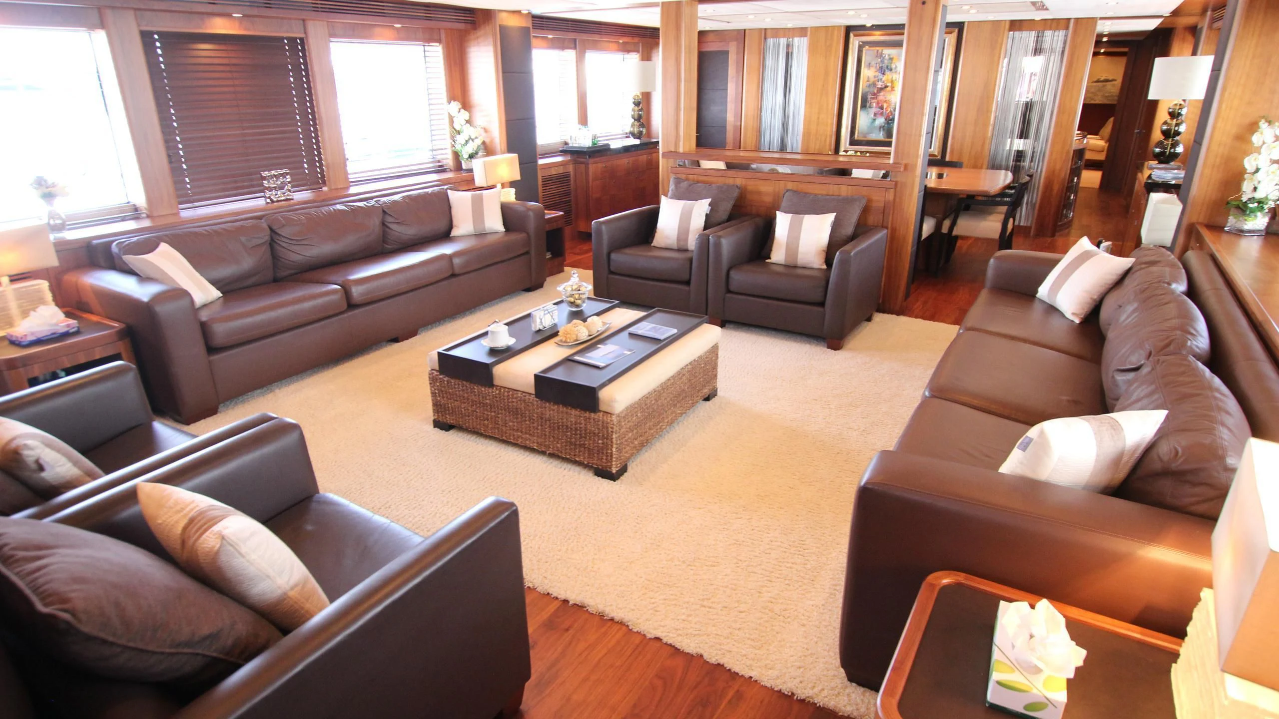 a living room with leather couches and a coffee table aboard THE DEVOCEAN Yacht for Sale