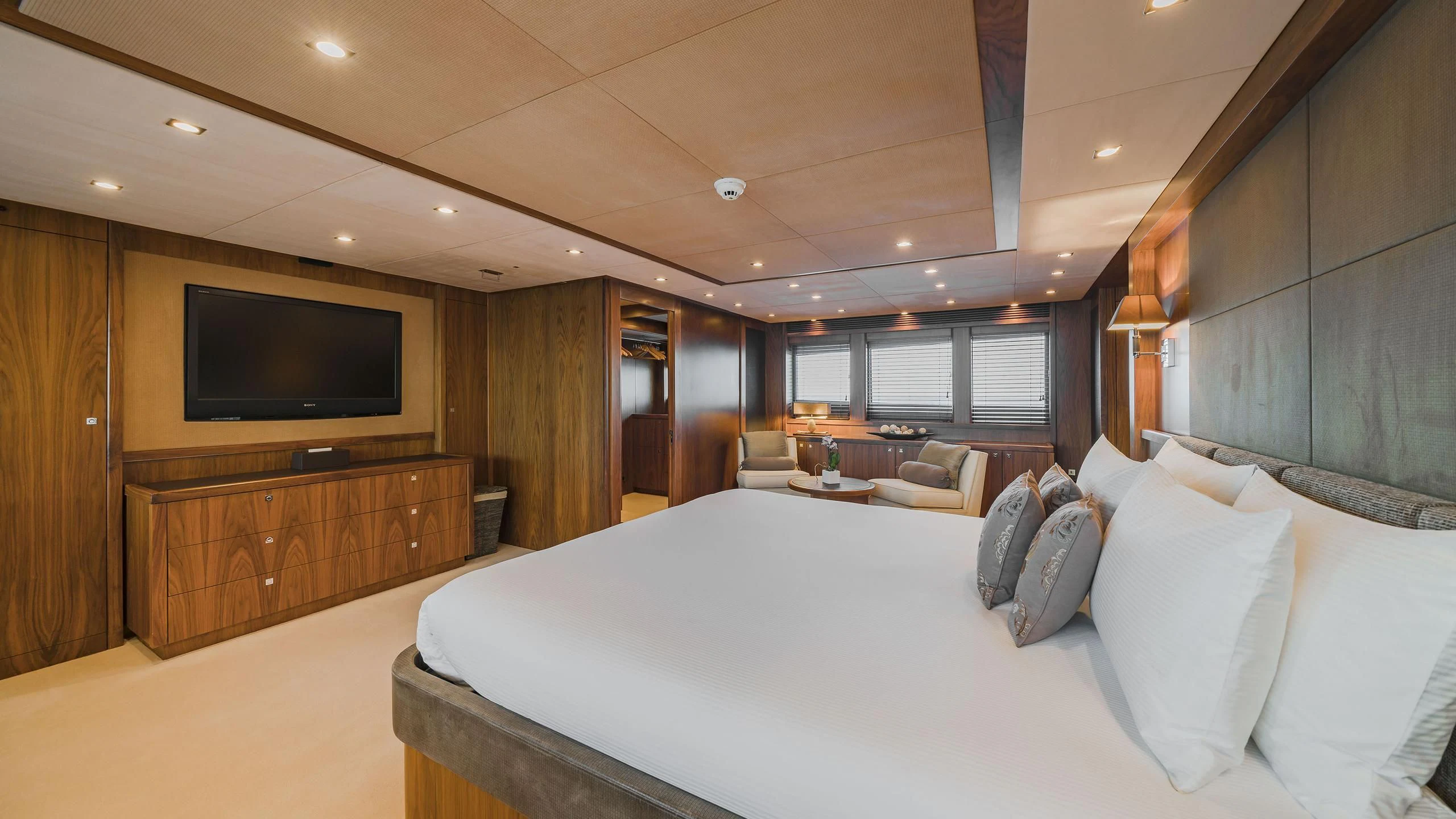 a large hotel room with a large bed and a tv aboard THE DEVOCEAN Yacht for Sale