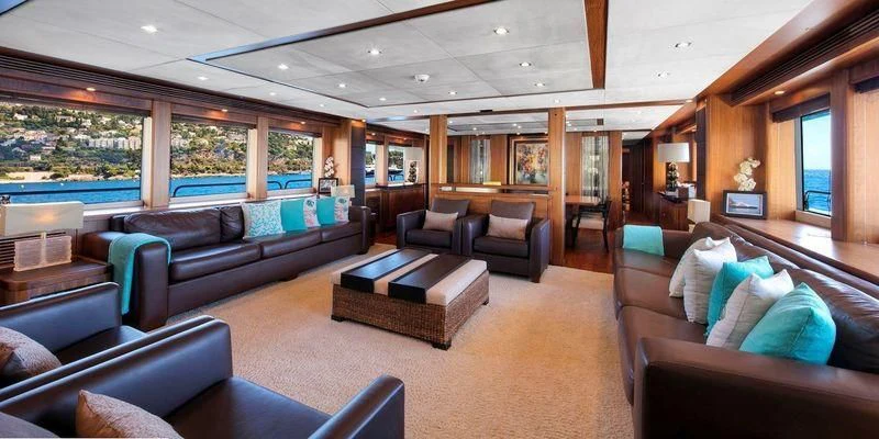 a living room with leather couches aboard THE DEVOCEAN Yacht for Sale