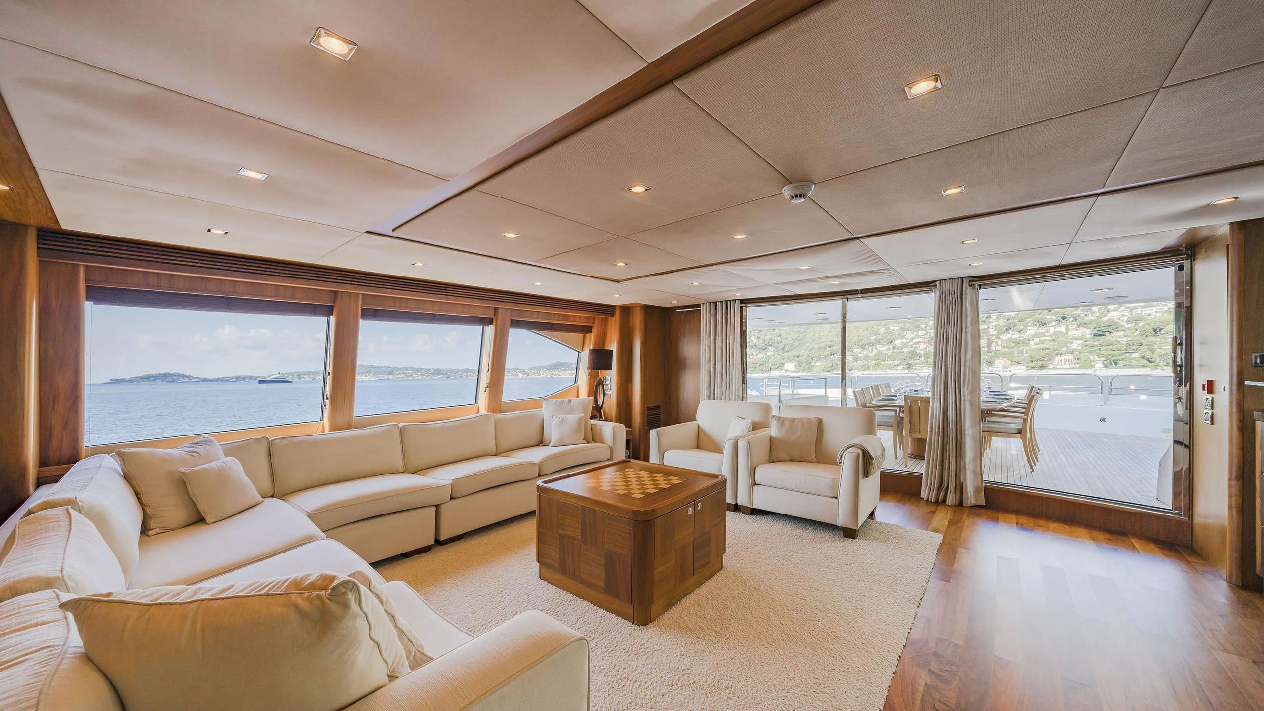 a living room with a large window aboard THE DEVOCEAN Yacht for Sale
