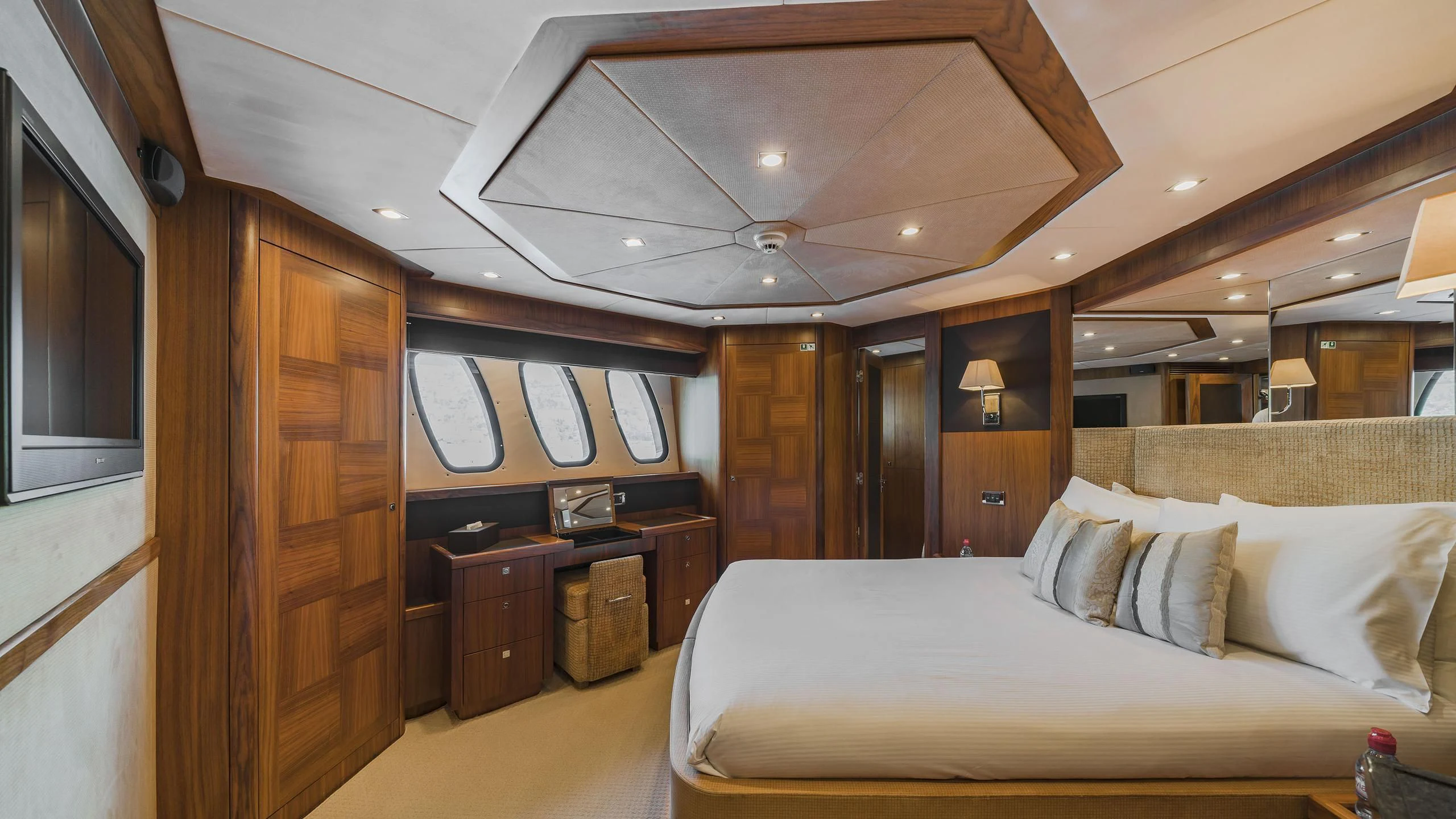 a bedroom with a bed and a desk aboard THE DEVOCEAN Yacht for Sale