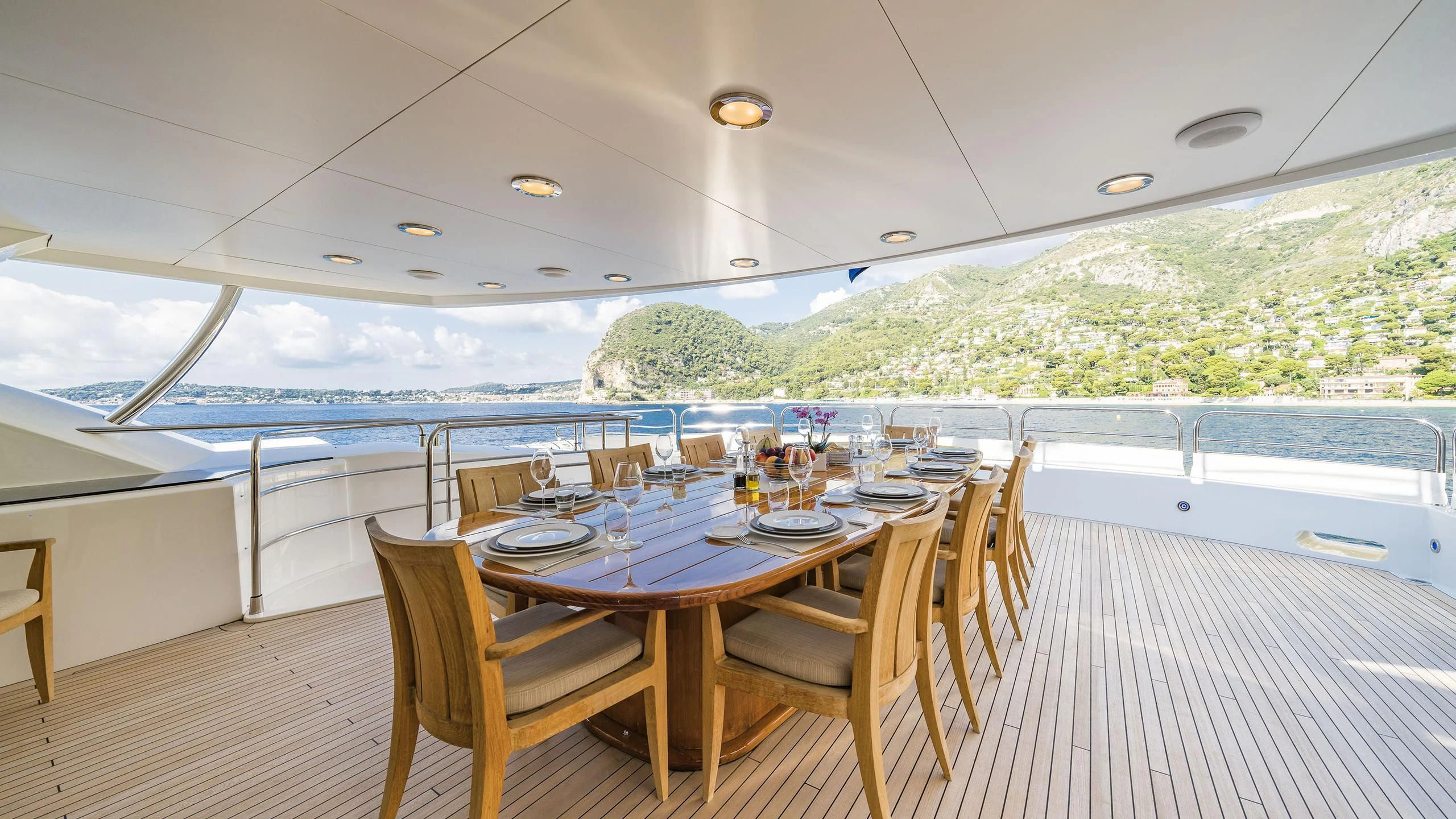 a dining table on a deck aboard THE DEVOCEAN Yacht for Sale