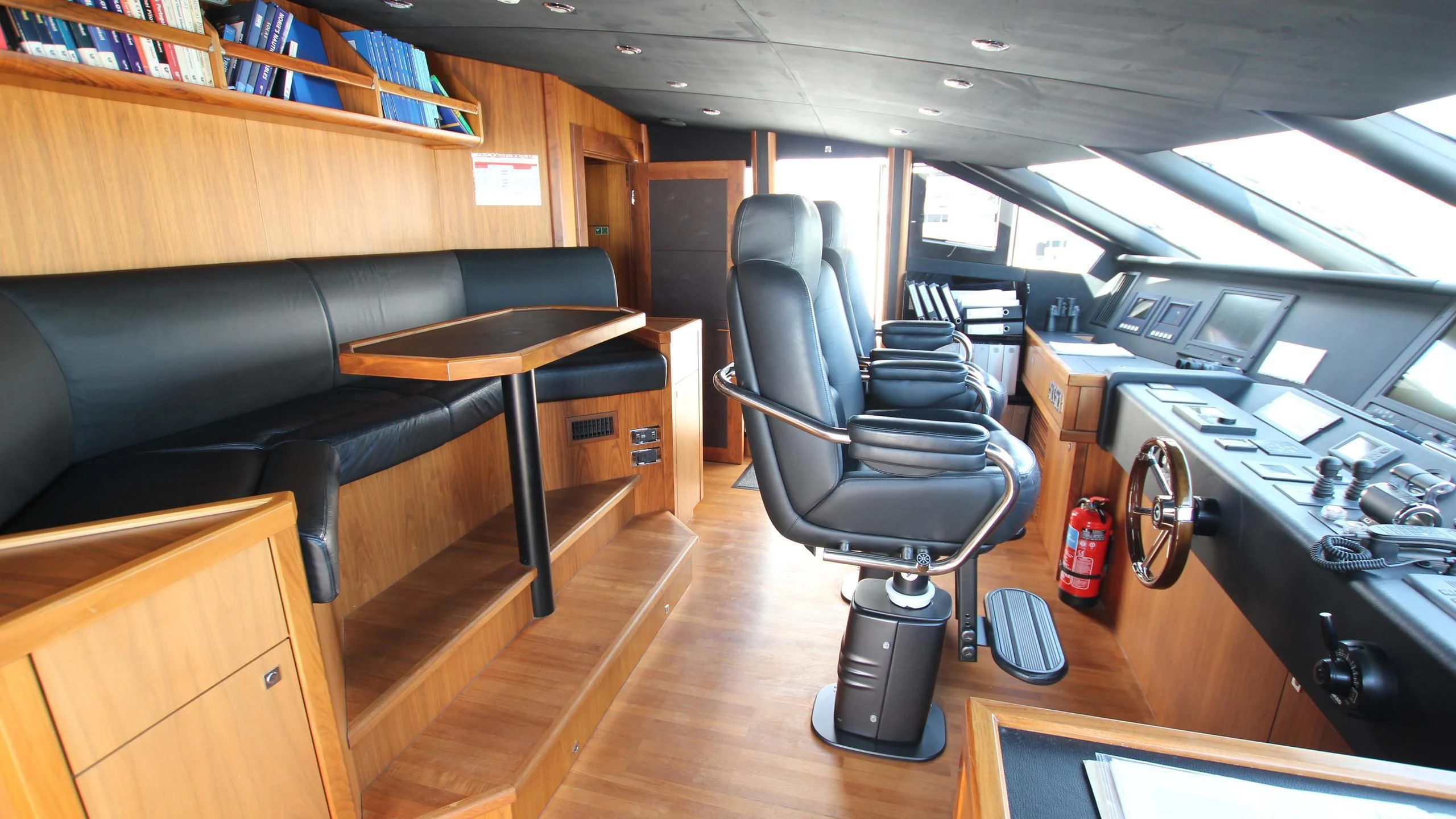 a room with a desk and chairs aboard THE DEVOCEAN Yacht for Sale