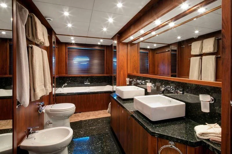 a bathroom with a large mirror aboard THE DEVOCEAN Yacht for Sale